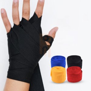 A hand wrapped in black boxing bandages next to rolls of blue, yellow, and red wraps.