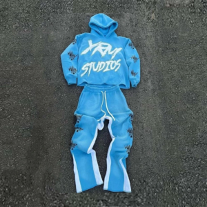 Unisex light blue streetwear tracksuit with XRM Studios text and star graphics.