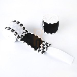 White cotton boxing hand wraps with black skull print and velcro closure.